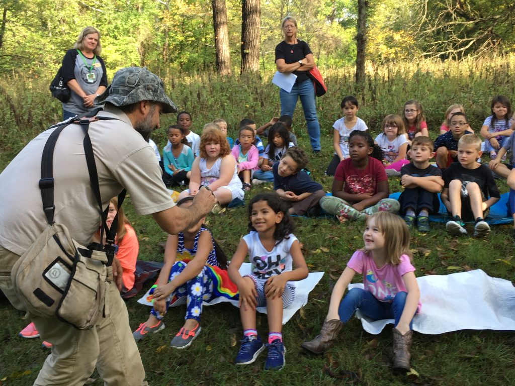 MRBO Director Ethan Duke shows a Black-capped Chickadee to a 2nd grade class at the Columbia Audubon Band With Nature event.